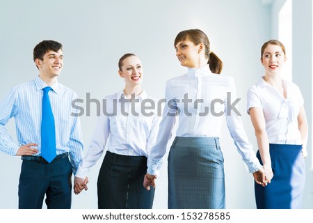 leadership team, a group of business people standing in a number of hand-in-hand, the leader stepped forward