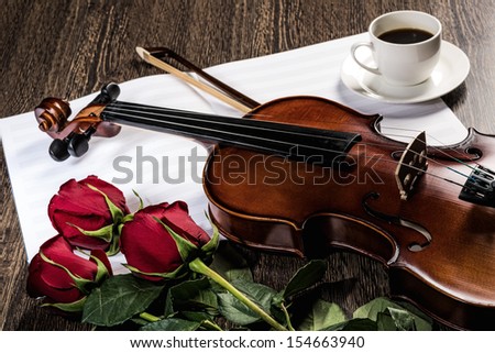 Violin, rose, cup of coffee and music books, still life
