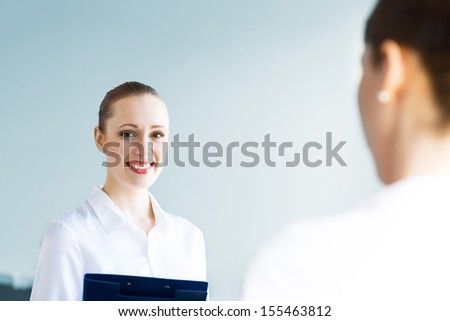 Young business woman talking with a colleague, interviews
