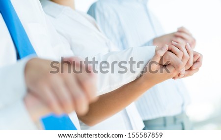 hands of businessmen, businessmen hold hands, stand in a row, the concept of teamwork