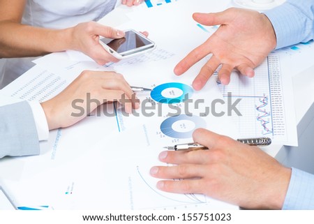 business people discuss meeting targets, sitting at the business table with documents