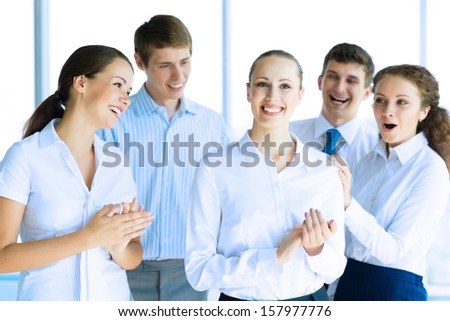 Successful business woman receiving congratulations from his colleagues, business success