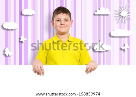 boy holding a white banner. place for text