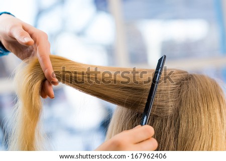 close up combing hair at the hairdresser