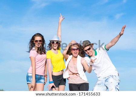 Group Of Young People Having Fun On A Blue Summer Sky