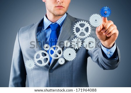 businessman touch the mechanism, run a successful business concept