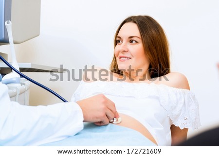 Young attractive pregnant woman on reception at the doctor, health check