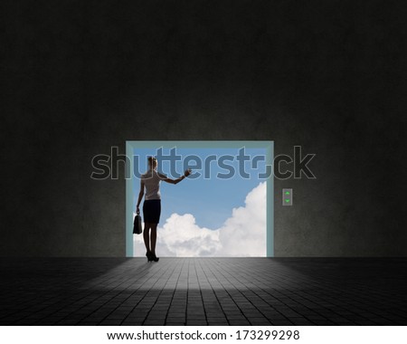 Business woman standing near an open door, the door sky and clouds