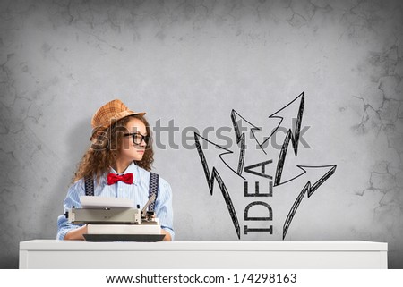 image of a young woman writer at the table with typewriter