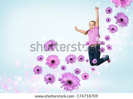 funny girl jumping around colored dots and flowers