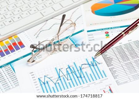 glasses, graphics and keyboard. business still life