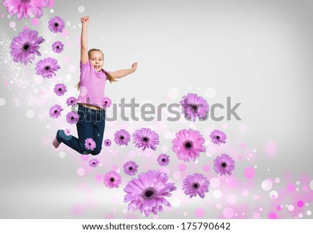 funny girl jumping around colored dots and flowers