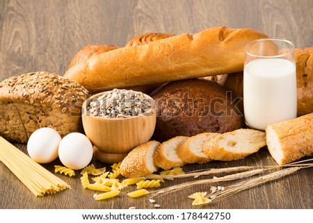 Fresh bread, eggs, pasta, glass of milk and grains. cook fresh bread at home