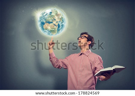 young man with a book thinks. keeps the finger symbol of the planet Earth. Elements of this image furnished by NASA,