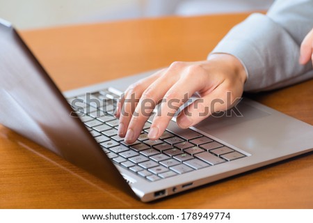 image of a business woman working with laptop, without a face