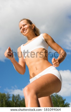 Young sports woman likes to run, view from below