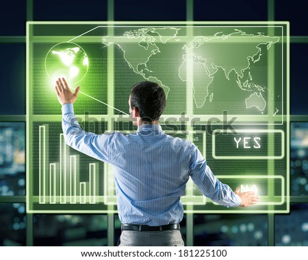businessman working with modern virtual technologies, stands back, hands touching the screen