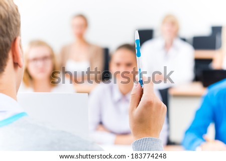 close-up of hands of a teacher with a ballpoint pen, the teacher focuses attention on himself gesture
