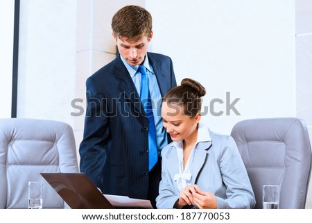 image of a two businessmen discussing documents, teamwork