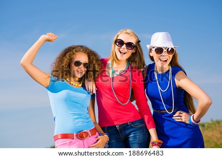 three young attractive girls having fun together, spend fun time with friends