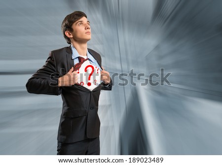 businessman breaks the shirt, under which the question marks behind the abstract background