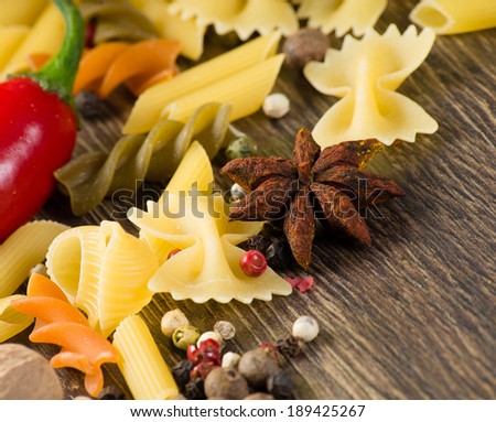close-up of anise, around the pasta on the wooden table, still life