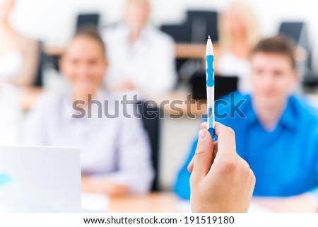 close-up of hands of a teacher with a ballpoint pen, the teacher focuses attention on himself gesture