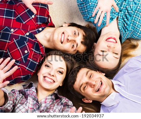 four young men lie together, four young men lie together, laughing and fooling around