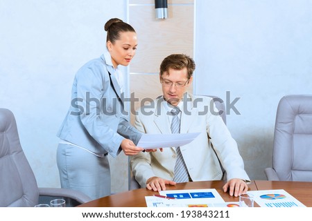 image of a two businessmen discussing documents, teamwork