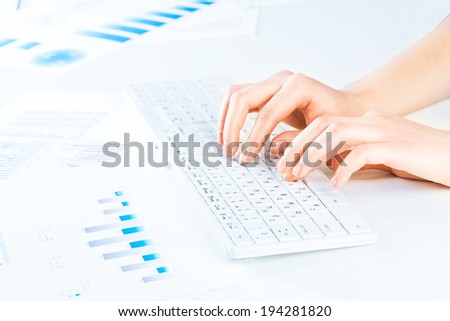 female hands typing on a keyboard text