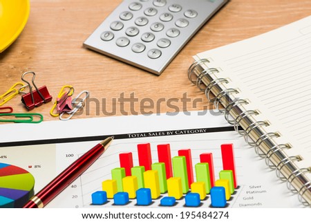 image of a notepad, pen and financial papers. business still life