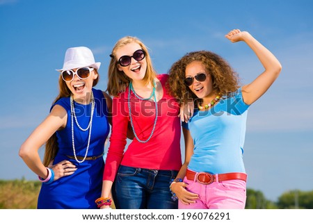 three young attractive girls having fun together, spend fun time with friends