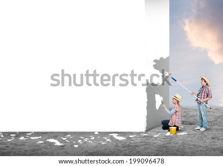 Cute little girl and boy painting the wall