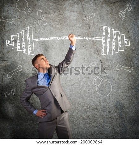 businessman holding a hand sketched barbell, concept achievements in business
