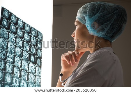 female doctor looking at the x-ray image attached to the glowing screen