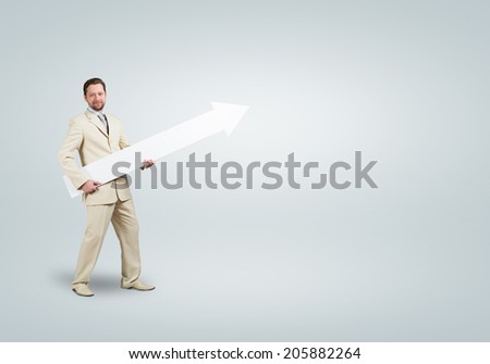 Handsome businessman with white blank arrow. Place for text