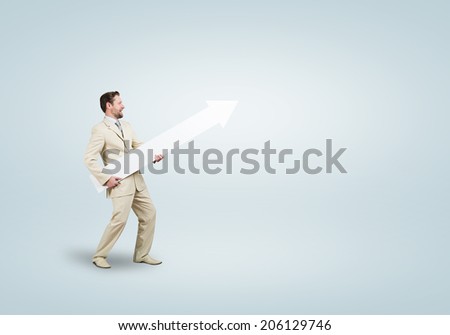 Handsome businessman walking with white blank arrow. Place for text