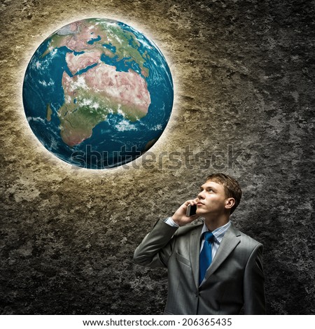 Young businessman looking thoughtfully at Earth plane. Elements of this image are furnished by NASA
