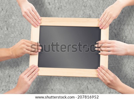 Close up of human hands holding blank wooden frame