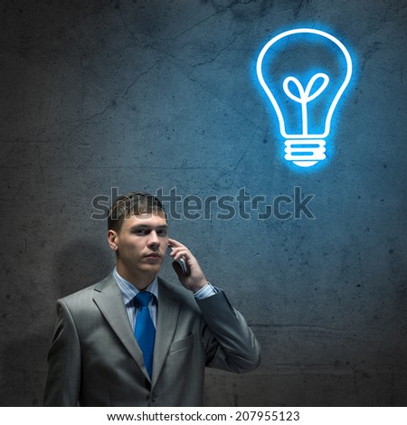 sad businessman talking on a cell phone with tears in his eyes