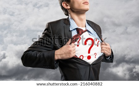 businessman breaks the shirt, under which the question, on a background of clouds