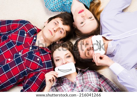 four young men lie together, applied to the face card with smiles
