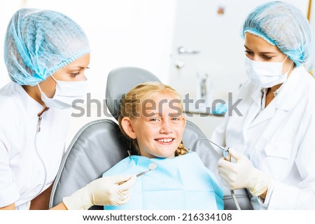 Little cute girl sitting in chair at dentist