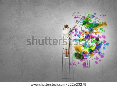 Back view of businesswoman standing on ladder and drawing on wall