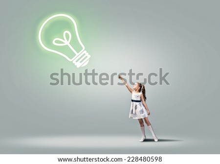 Cute girl in dress with light bulb on rope
