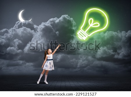 Cute girl in dress with light bulb on rope
