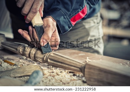 Close up carpenter\'s hands that work with cutter