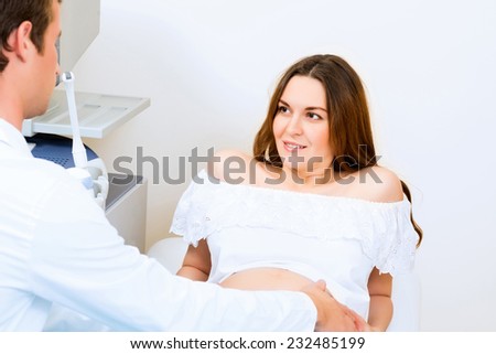 Young attractive pregnant woman on reception at the doctor, health check