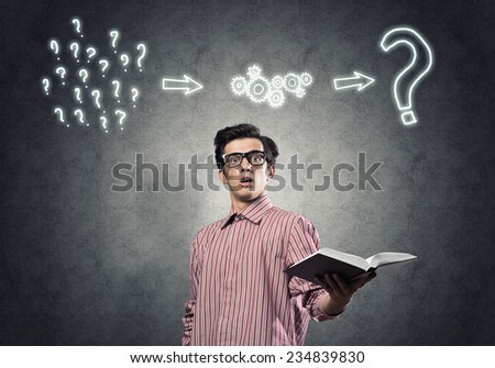 Young funny man in casual with book in hand