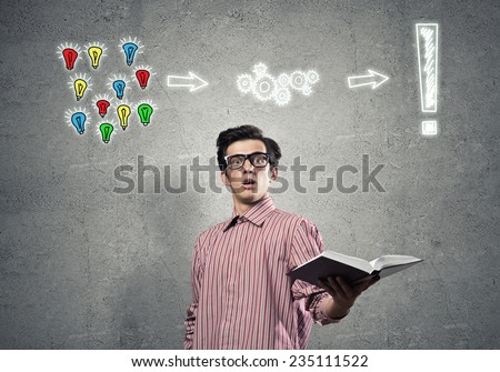 Young funny man in casual with book in hand
